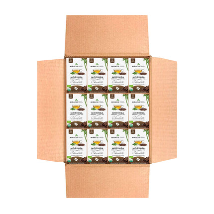 The open cardboard box reveals neatly arranged packets of Miracle Tree Organic Moringa Tea, Chocolate. Each packet emphasizes nutrient-dense organic moringa with chocolate imagery, highlighting its superfood qualities and fair trade ingredients. The box is displayed on a white background.