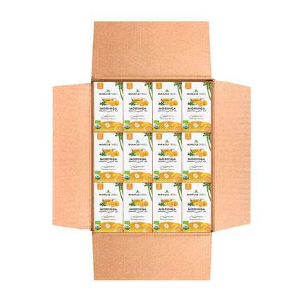 An open cardboard box displays several Miracle Tree Organic Moringa Tea, Lemon boxes organized in four rows, featuring lemon images and branding labels that emphasize this caffeine-free superfood.