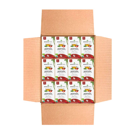 An open cardboard box reveals multiple packages of Miracle Trees Organic Moringa Tea, Strawberry flavor. The predominantly white packaging features green and red text with images of Moringa leaves and a steaming cup, offering invigorating, caffeine-free superfood tea.