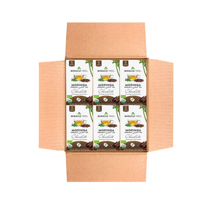 A cardboard box holds 10 packets of Miracle Trees Organic Moringa Tea, Chocolate. Each packet shows green leaves and cocoa illustrations, highlighting the natural, superfood benefits and caffeine-free experience offered by this organic tea.