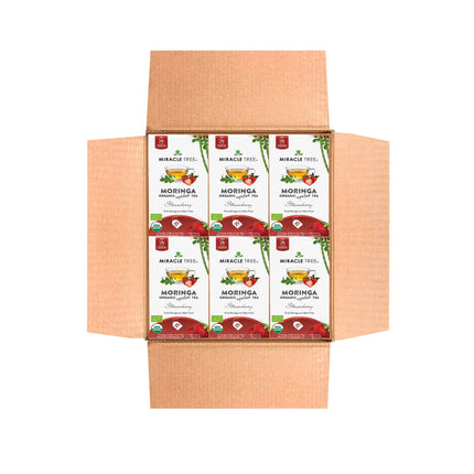 Open cardboard box containing six boxes of Miracle Tree Organic Moringa Tea, Strawberry. The caffeine-free delight features a vibrant red and green design with organic certification labels proudly displayed.