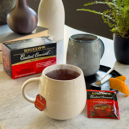 Box of  Constant Comment Tea with cup of tea and foil packet