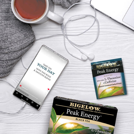 Box of Peak Energy Plus Extra L-Theanine and Caffeine Black Tea with cup of tea and foil