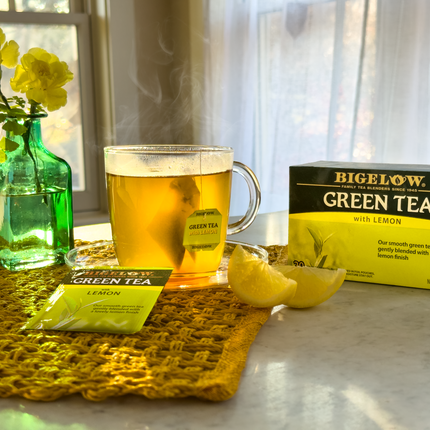 Cup of Green Tea with Lemon with vase of flowers